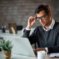 mid-adult-businessman-using-computer-while-working-office_637285-740